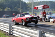 Red CAMARO popping a wheelie